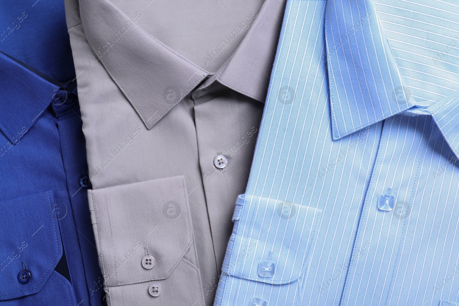 Photo of Stylish shirts as background, top view. Dry-cleaning service