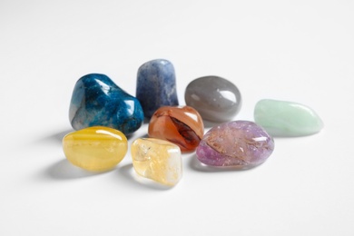 Pile of different beautiful gemstones on white background