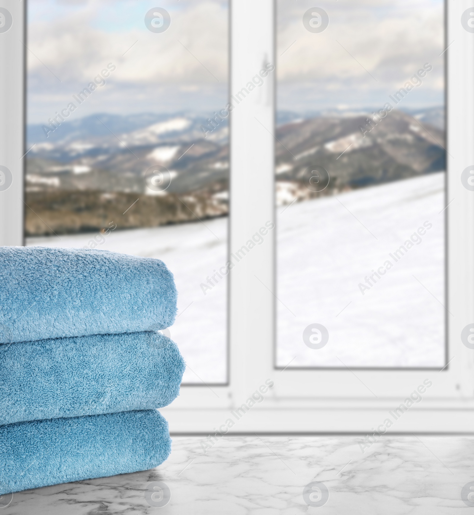 Image of Fresh towels on marble table and window with beautiful view indoors