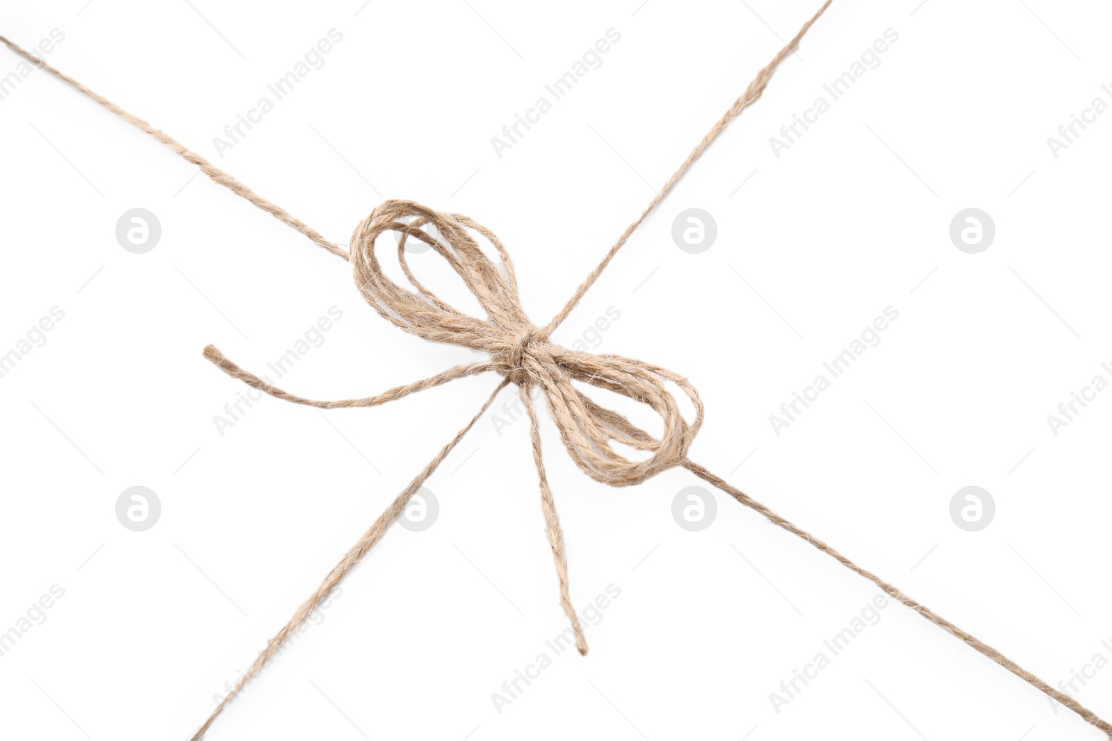 Photo of Linen rope string with bow isolated on white, top view