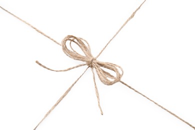 Photo of Linen rope string with bow isolated on white, top view