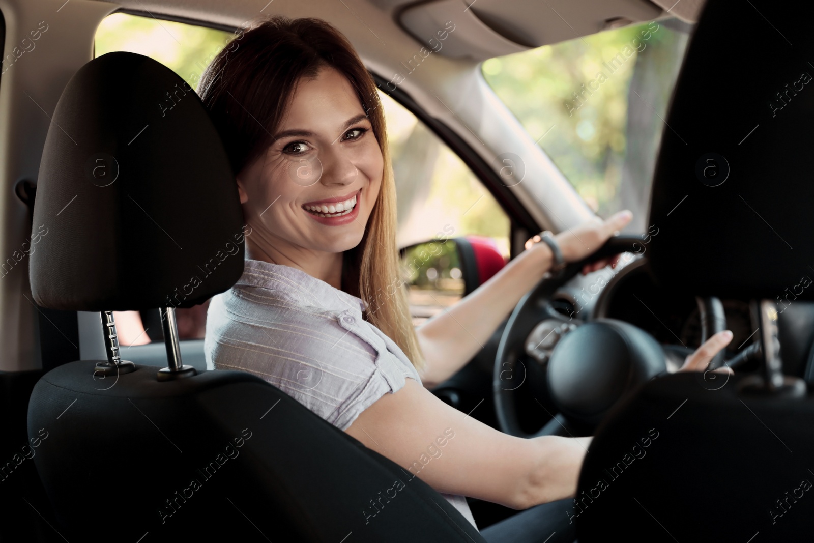 Photo of Happy beautiful woman driving modern car