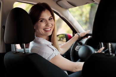 Photo of Happy beautiful woman driving modern car