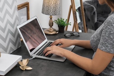 Woman using computer in home office. Stylish workplace