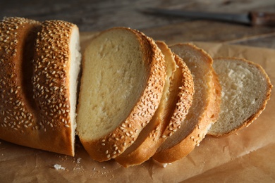 Tasty wheat bread on parchment paper, closeup