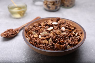 Photo of Tasty granola served with nuts and dry fruits on light grey table