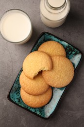 Delicious Danish butter cookies and milk on grey table, flat lay
