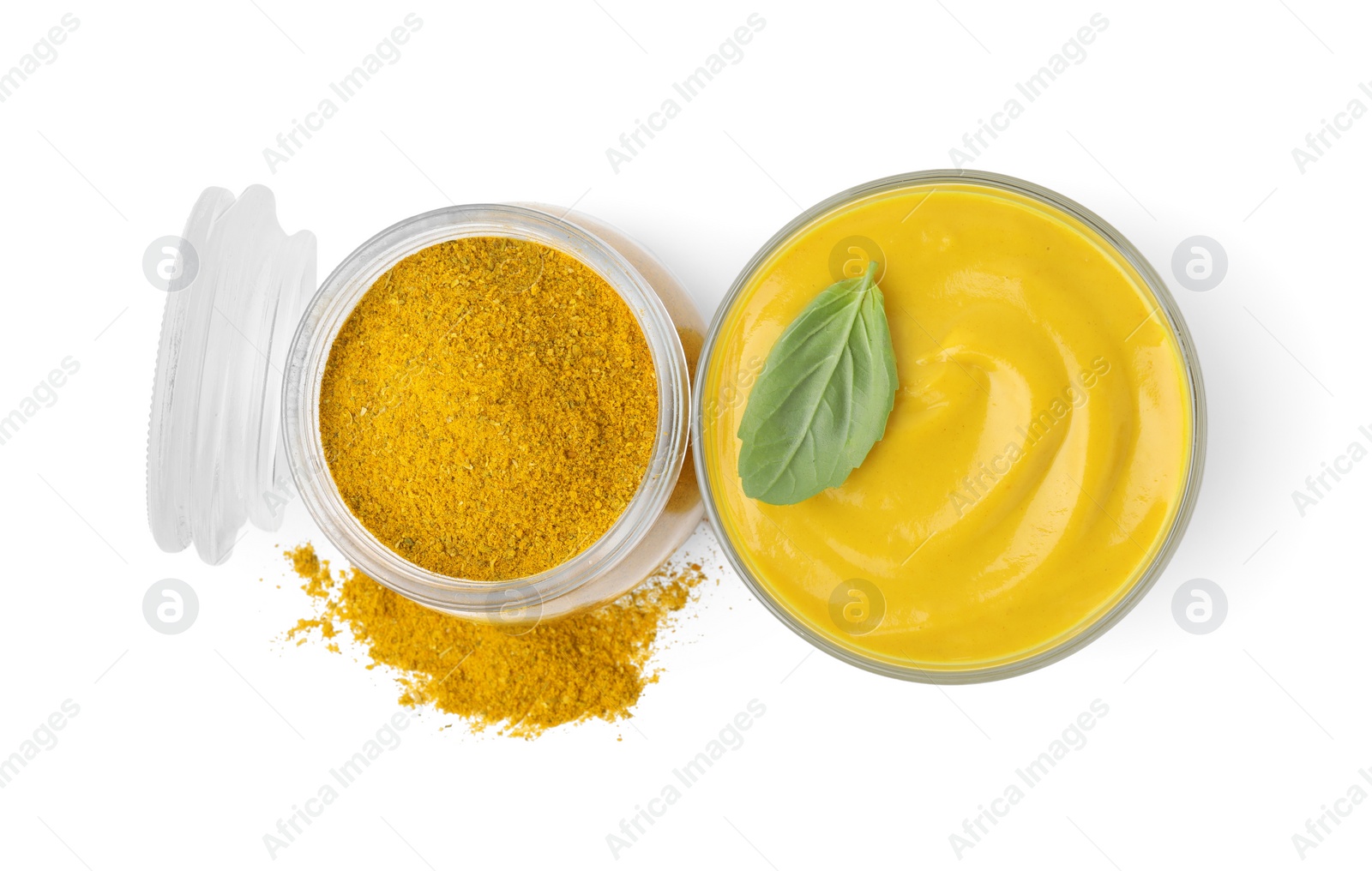 Photo of Tasty curry sauce, powder and basil leaf isolated on white, top view