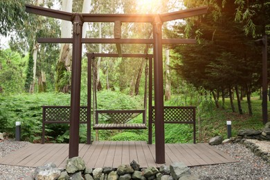 Photo of Beautiful brown metal swing in tranquil park
