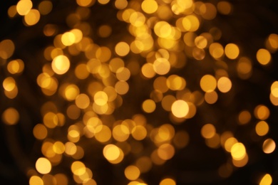 Photo of Gold glitter with bokeh effect on dark background