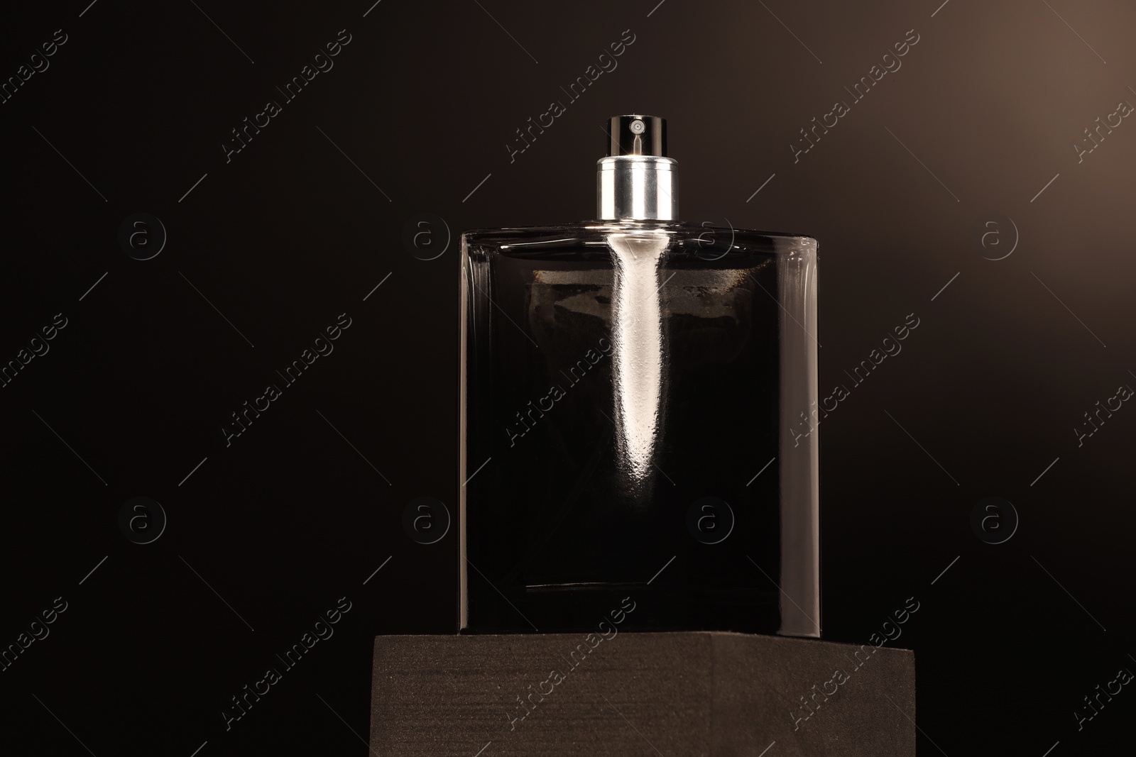 Photo of Luxury men`s perfume in bottle against dark background