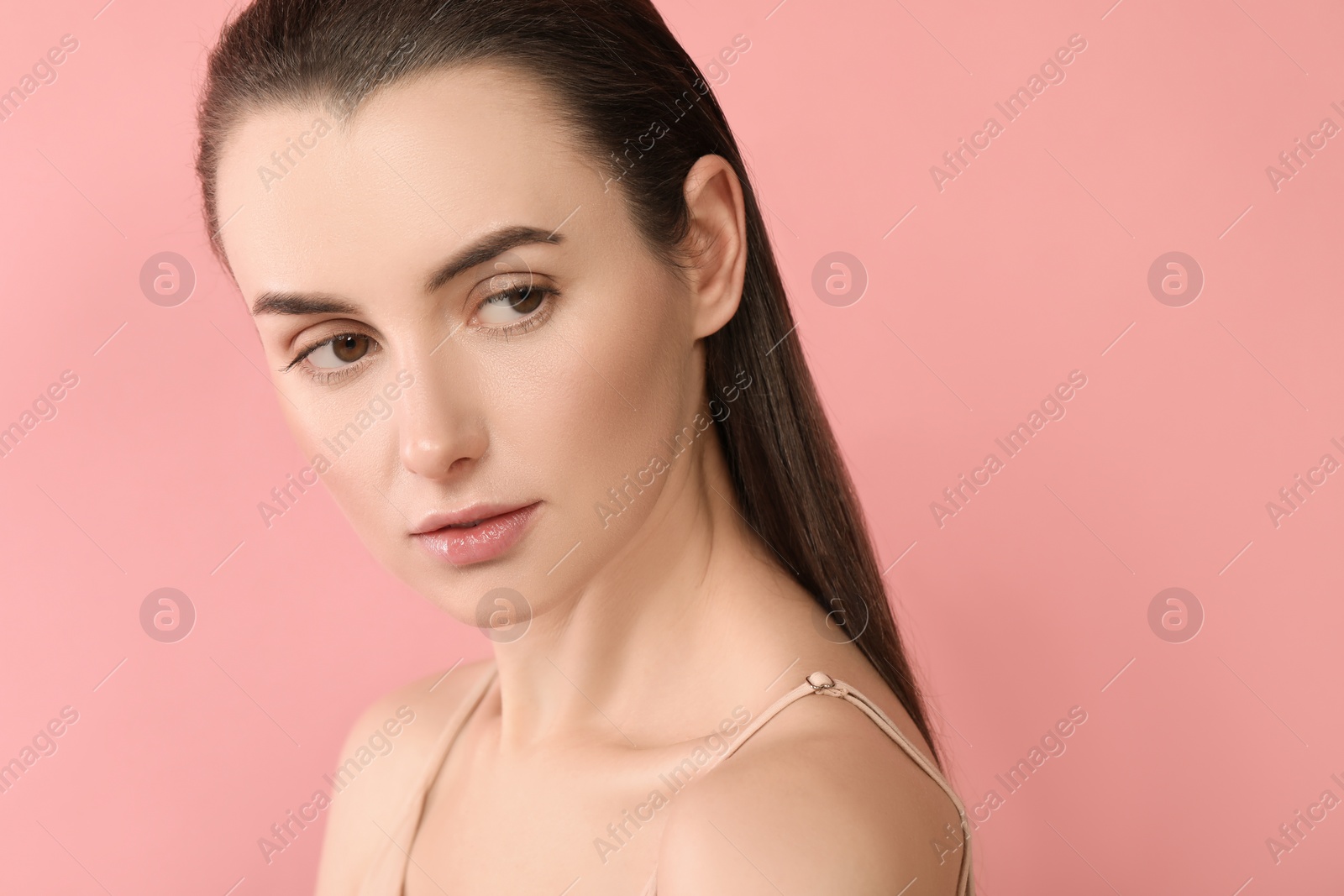 Photo of Portrait of beautiful young woman on pink background. Space for text