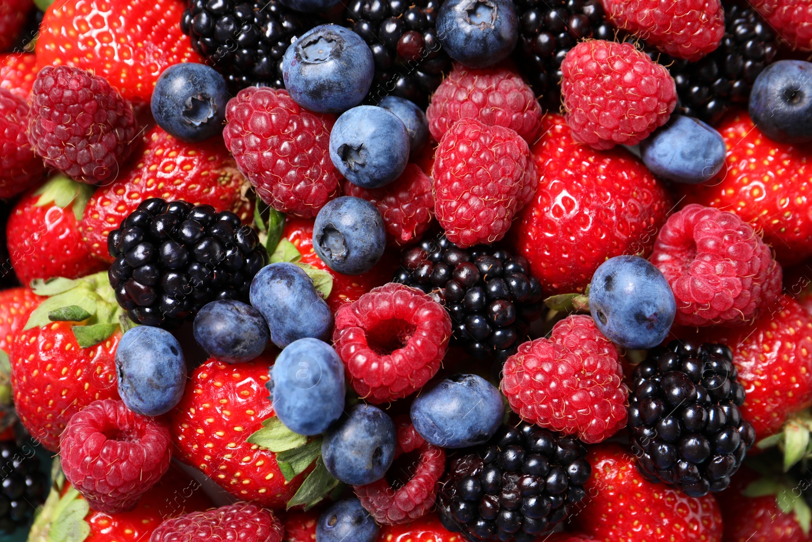 Photo of Many different fresh ripe berries as background, top view