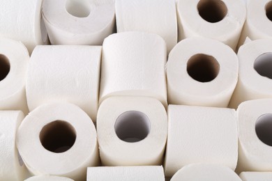 Photo of Many soft toilet paper rolls as background, above view