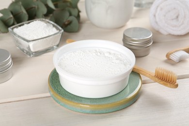 Photo of Composition with tooth powder on white wooden table