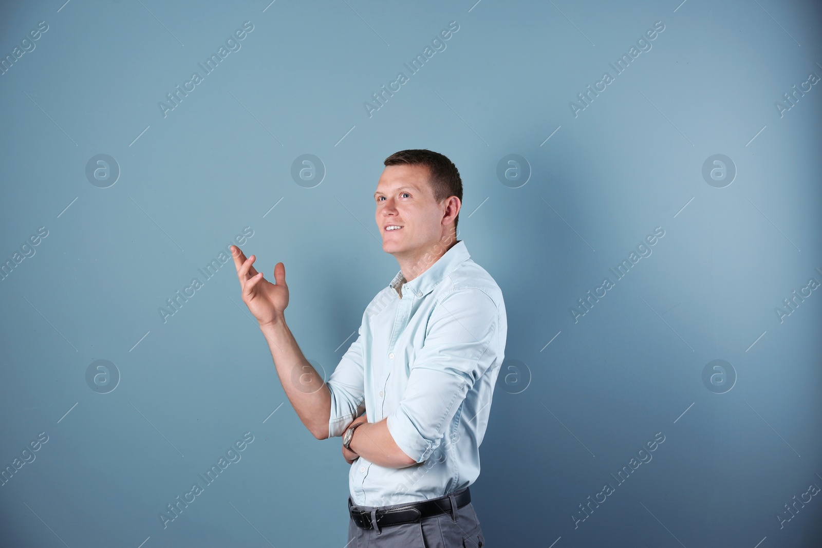 Photo of Handsome young man on color background