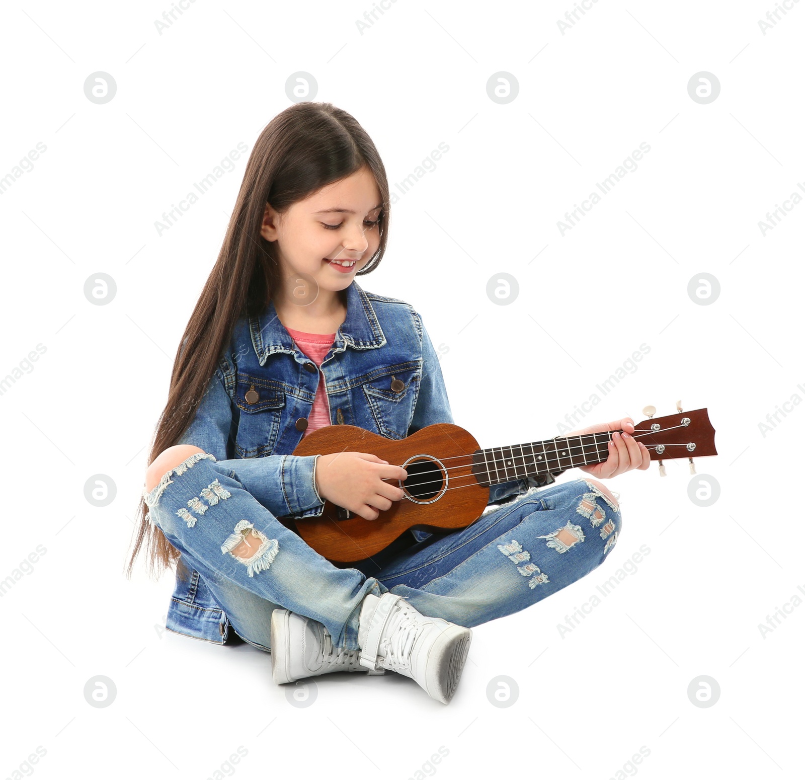 Photo of Little cheerful girl playing guitar, isolated on white