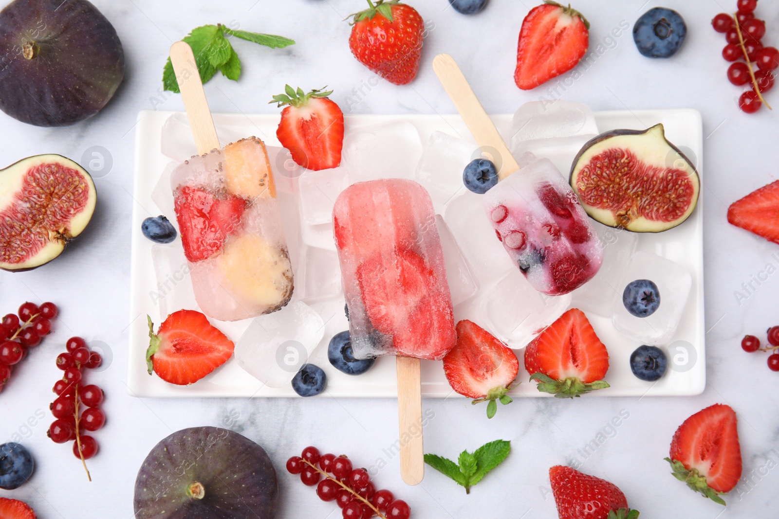 Photo of Flat lay composition with fruit and berry ice pops on light table