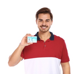 Happy young man with driving license on white background