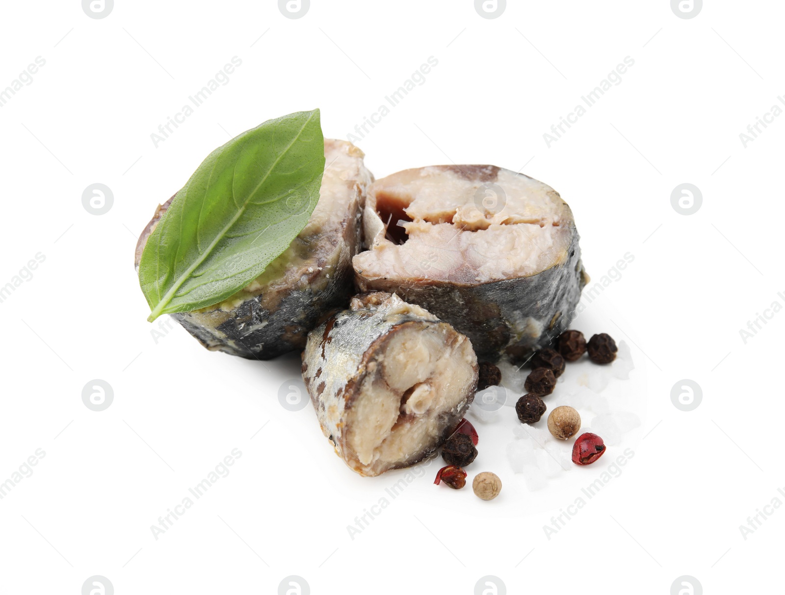 Photo of Canned mackerel chunks with basil and peppercorns on white background