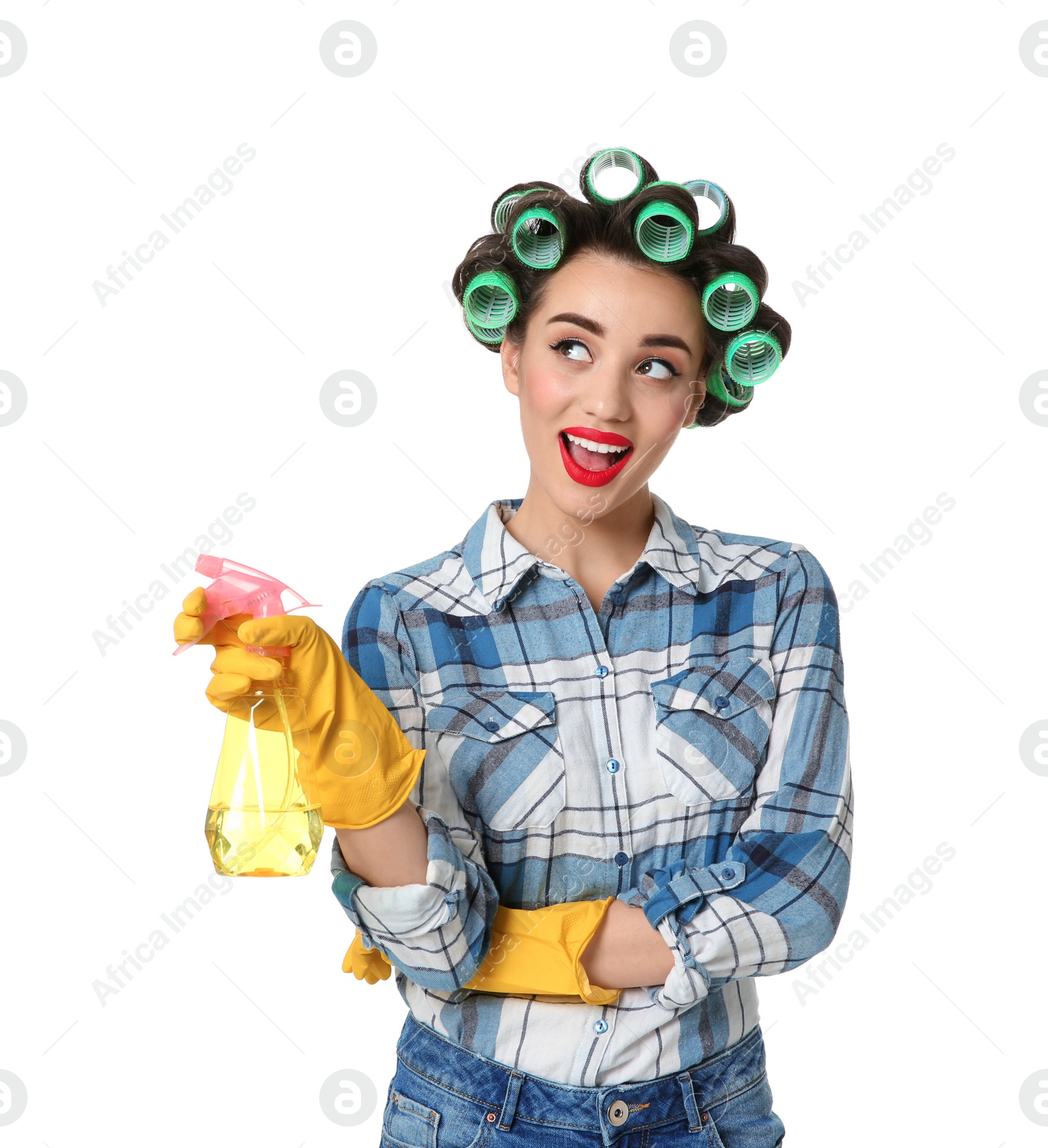 Photo of Funny young housewife with hair rollers holding detergent on white background