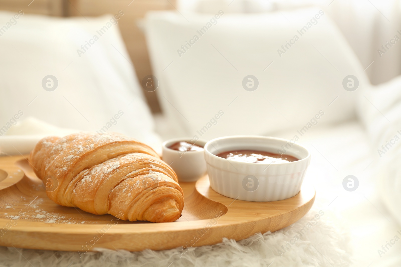 Photo of Delicious croissant and jam on tray. Delicious morning meal