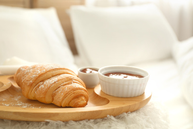 Photo of Delicious croissant and jam on tray. Delicious morning meal