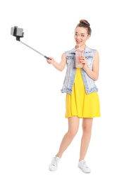 Photo of Young beautiful woman taking selfie against white background