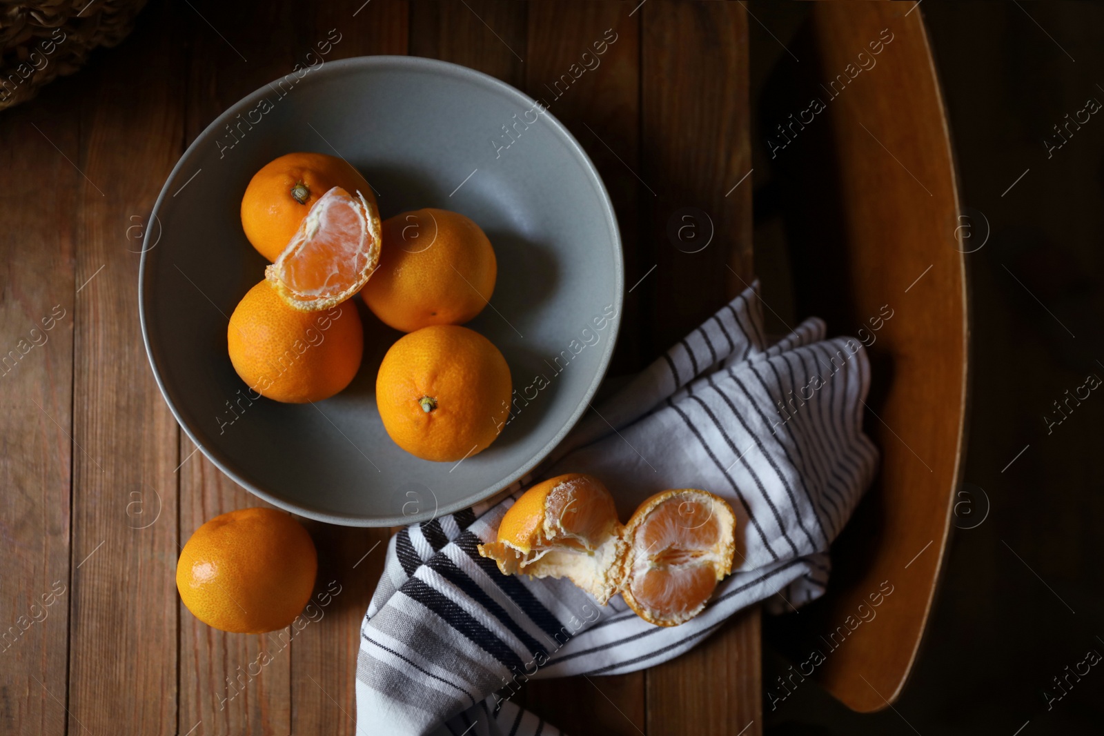 Photo of Fresh ripe tangerines on wooden table, flat lay
