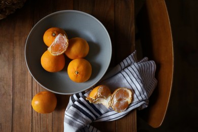 Fresh ripe tangerines on wooden table, flat lay