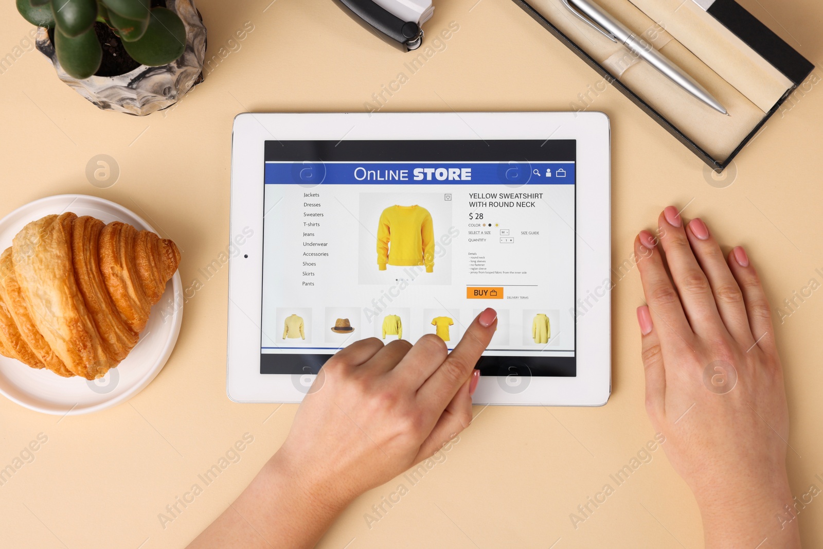 Photo of Woman with tablet shopping online on beige background, top view