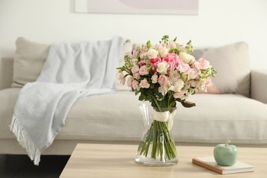 Photo of Beautiful bouquet of fresh flowers in vase on wooden table indoors