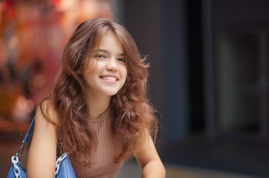 Photo of Portrait of beautiful teenage girl in shopping mall. Space for text