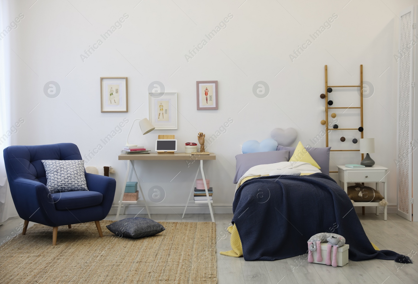 Photo of Modern teenager's room interior with bed and armchair