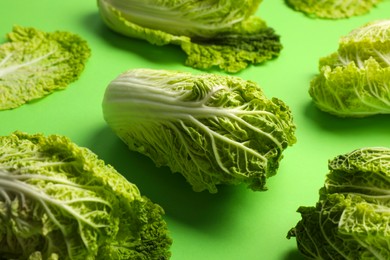 Photo of Fresh ripe Chinese cabbages on light green background