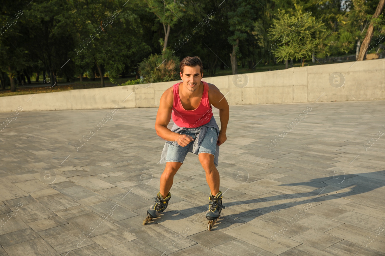 Photo of Handsome young man roller skating on city street