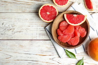 Flat lay composition with grapefruits and space for text on wooden background