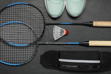 Photo of Different sports equipment on black table, flat lay