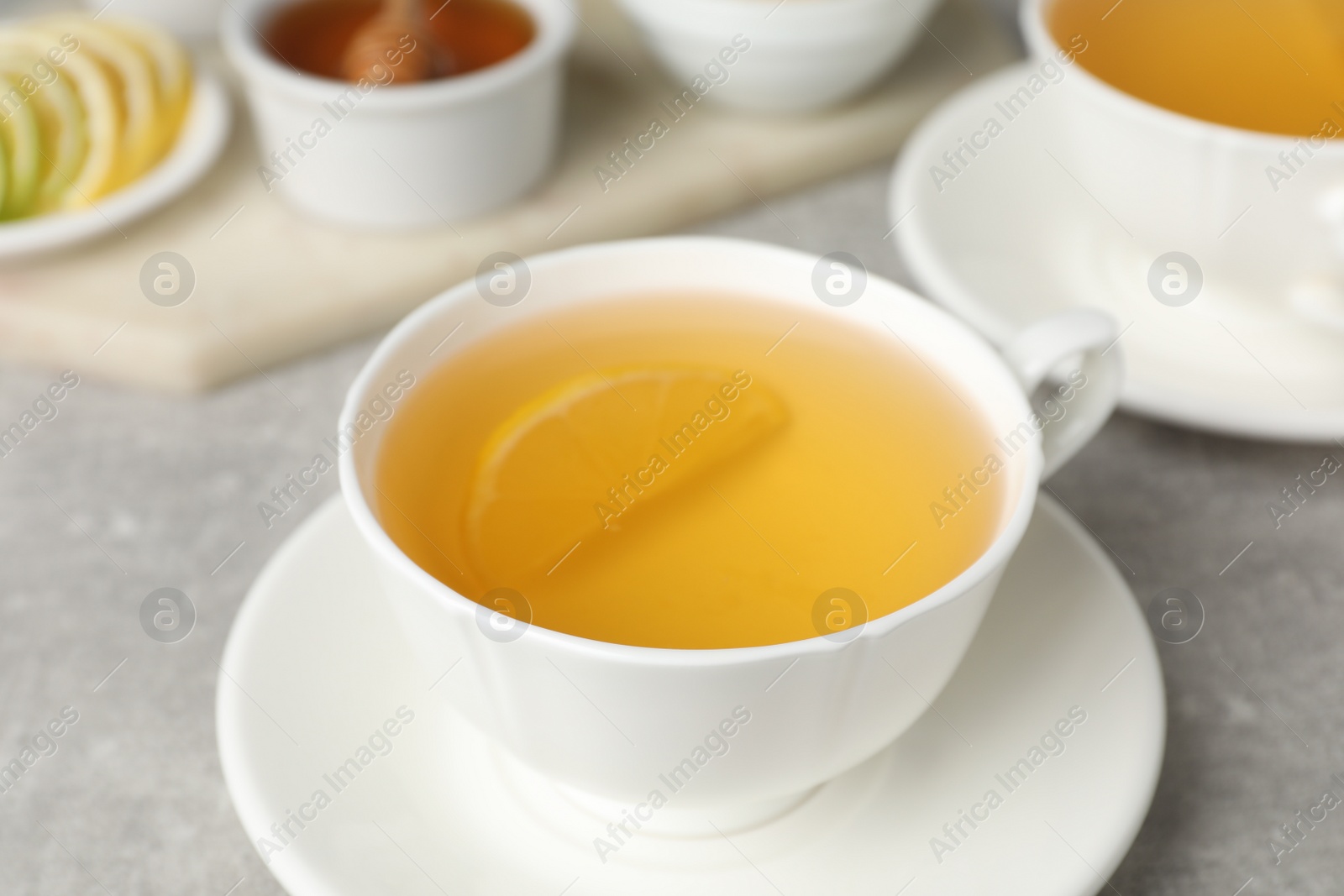 Photo of Immunity boosting drink on light grey marble table, closeup