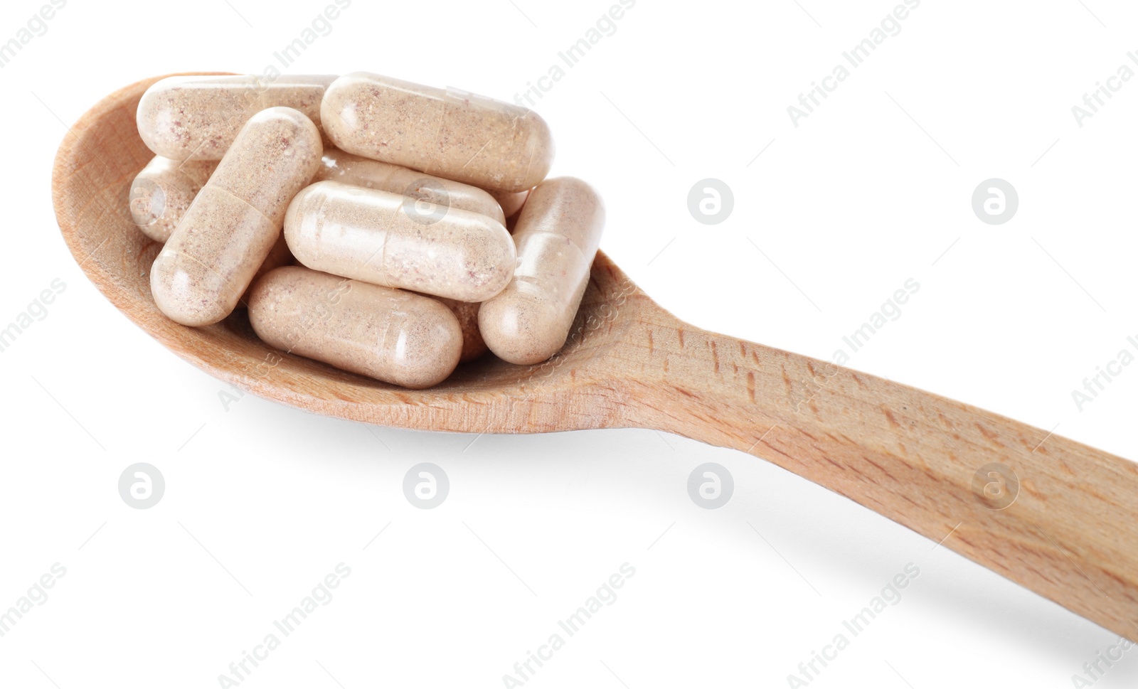 Photo of Gelatin capsules in spoon on white background