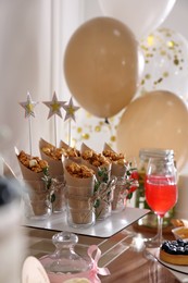 Photo of Delicious party treats on wooden table indoors