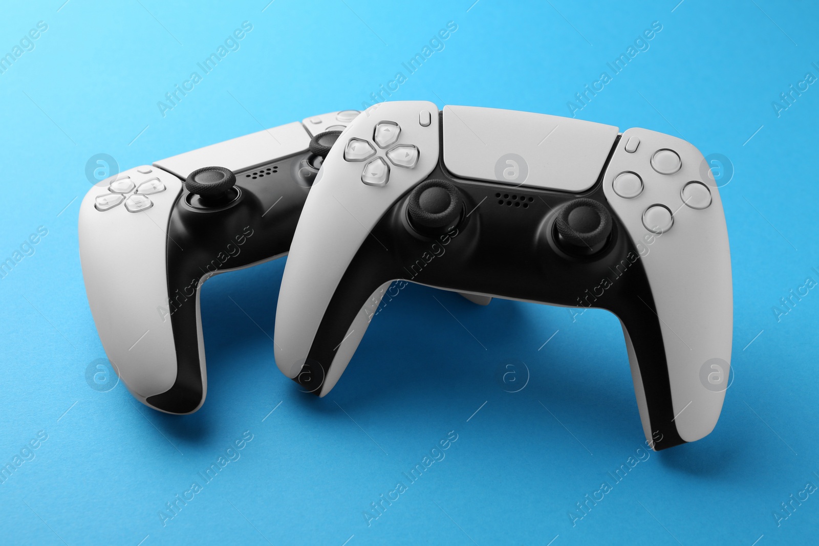 Photo of Wireless game controllers on light blue background