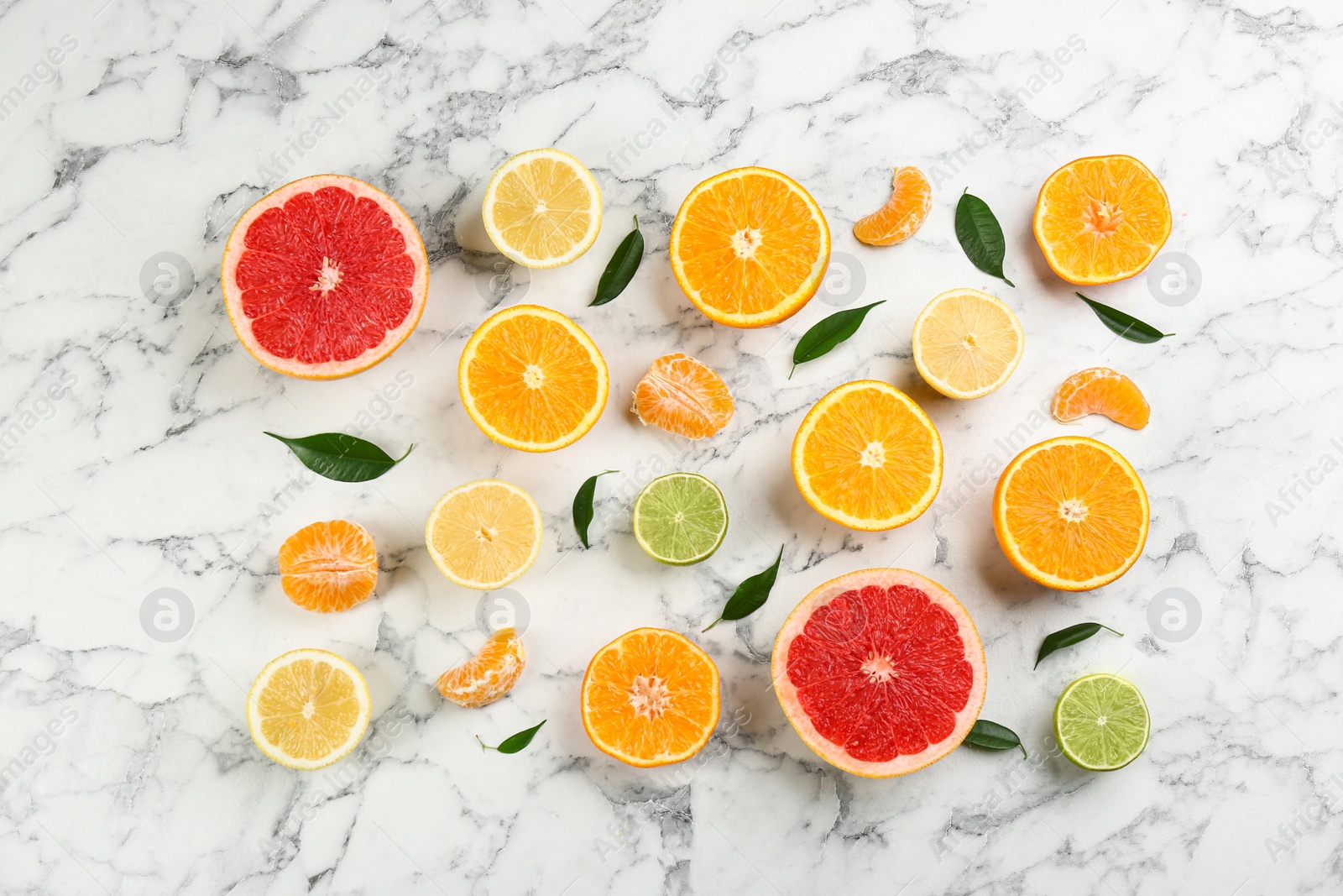 Photo of Flat lay composition with tangerines and different citrus fruits on white marble background