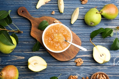 Photo of Tasty homemade pear jam and fresh fruits on blue wooden table, flat lay
