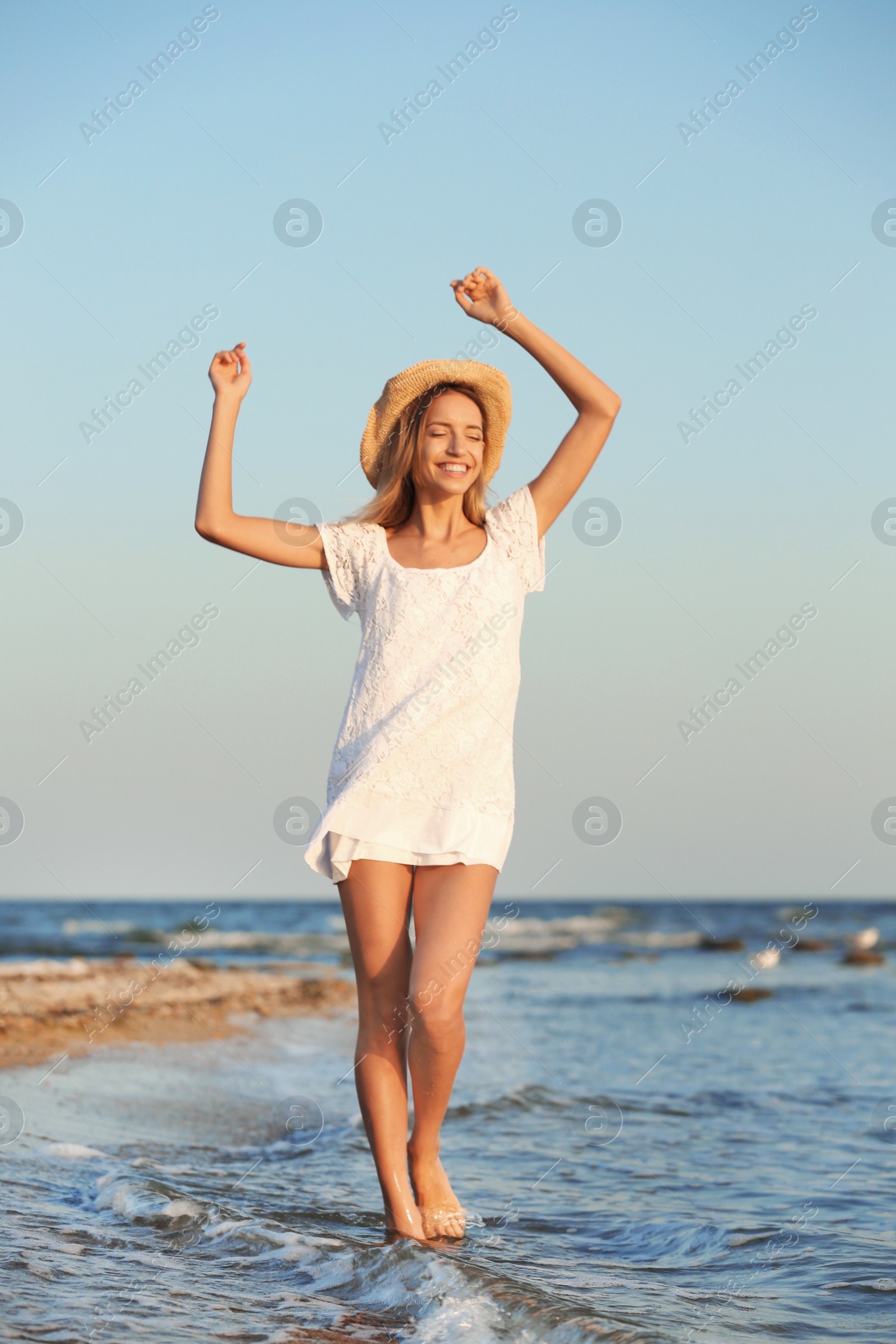 Photo of Young woman enjoying sunny day on beach