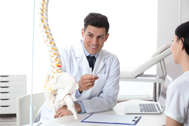 Photo of Young woman visiting orthopedist in medical office