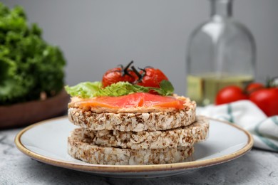 Photo of Crunchy buckwheat cakes with salmon, tomatoes and greens on table