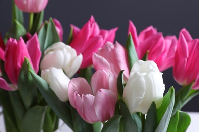 Photo of Beautiful tulip flowers on color background, closeup