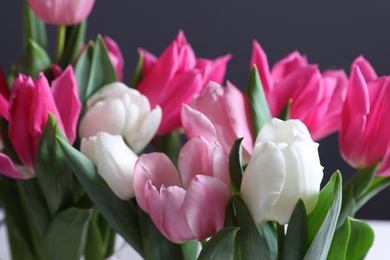 Beautiful tulip flowers on color background, closeup