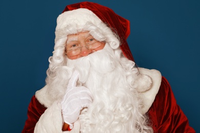 Photo of Happy authentic Santa Claus on blue background